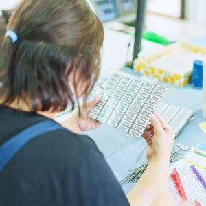 Female staff visually inspecting barcode labels
